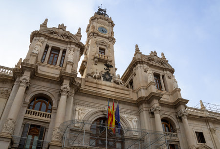 Valencia City Hall in Plaza del Ayuntamiento during Fallas. Crowds gather for the Mascletà, a thunderous firework show, safely watched from behind the protective cageの写真素材