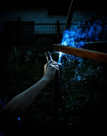 Welding steel structures and bright sparks with lens flare in steel industryの写真素材