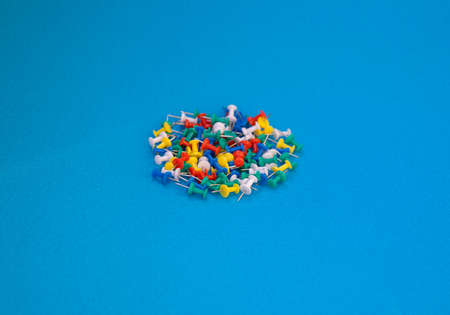 Multicolor push pins. A great view of multicolored push pins against a blue background