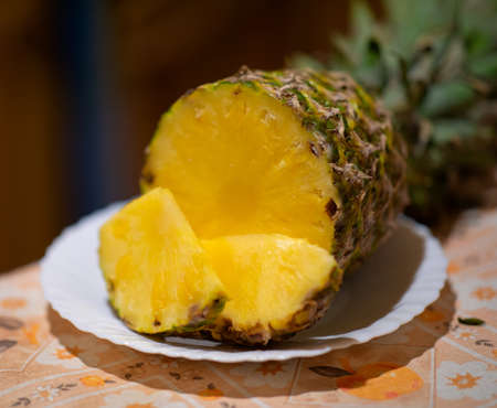 Fresh pineapple fruit on a white plate