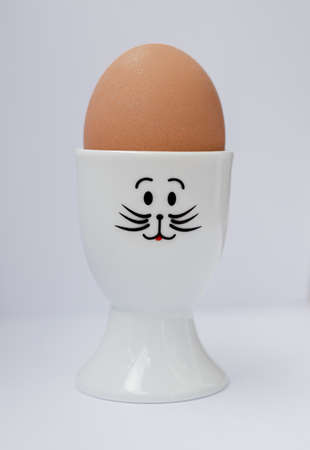 Egg in an eggcup on a white background