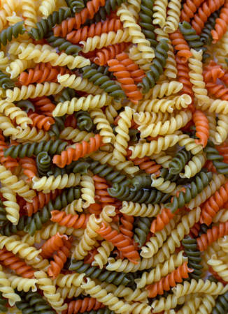 Tricolor, dry and raw pasta, food for backgroundの写真素材