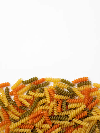 Tricolor, dry and raw pasta on a white backgroundの写真素材