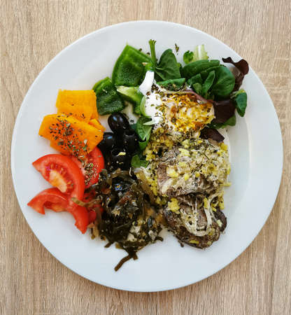A healthy and nutritious lunch. Turkey liver with onion in cream, seaweed salad, black olives,...