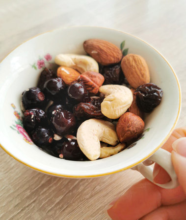 Group of mixed nuts and berries. Cashews, almonds, hazelnuts, black currants. Healthy food and snackの写真素材
