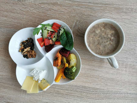 A healthy and nutritious breakfast. Porridge with chia seeds, vegetables, nuts and cheese