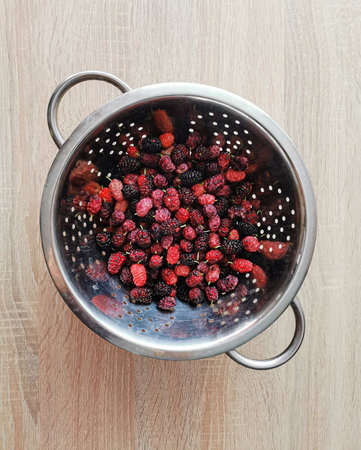 Fresh, ripe red and black mulberries are beneficial for health, blueberries contain antioxidantsの写真素材