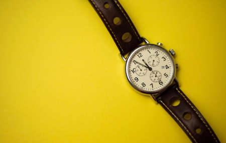 Classic men's watch with a leather strap showing five minutes to midnight. 5 minutes to twelve o'clockの写真素材