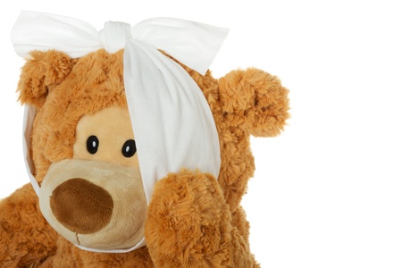Teddy bear with toothache holding his jaw and isolated on a white backgroundの写真素材