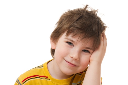The smiling boy with the tousled hair on a white backgroundの写真素材