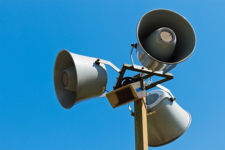 Three loudspeakers on a column against the blue skyの写真素材