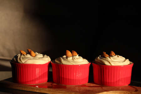 Dessert. Tasty cupcakes with almond in ramekins.