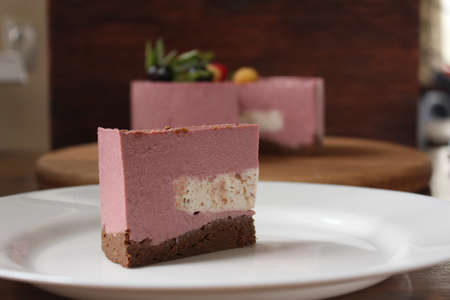 A piece of homemade mousse sweet pink cake on the plate. The concept of proper nutrition. A piece of...