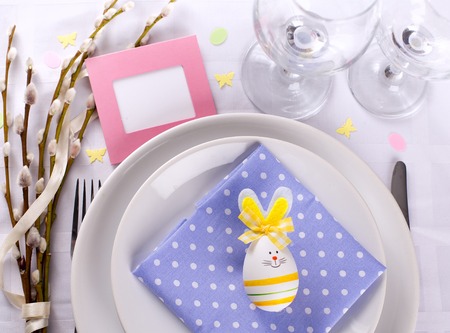 easter table setting with eggs willow branches on white backgroundの写真素材