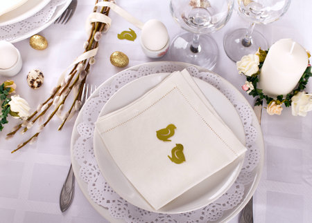 easter table setting in white and gold colors decorative elements