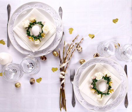 easter table setting in white and gold colors decorative elements
