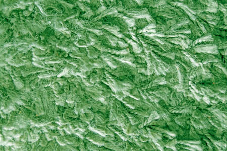 Texture of long hair carpet in green color, fur texture closeup for designers and backgroundの写真素材