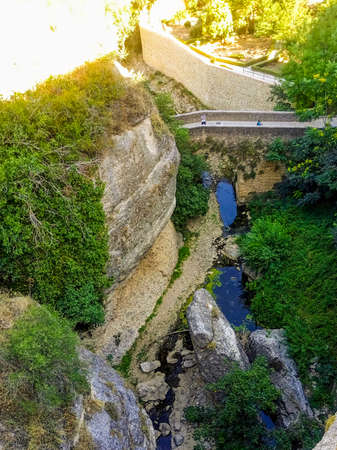 River passing through old bridge in the beautiful city of Ronda, Malaga, Andalusia, Spainの写真素材