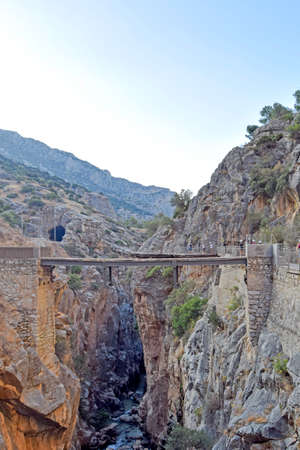 Very narrow bridge between two mountains of the Caminito del Rey in Desfiladero de los Gaitanes de Sierra de Ardales, Malaga, Andalusia, Spainの写真素材
