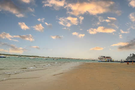 Sunset on the beach of Sanlucar de Barrameda, with the sun setting behind the horizon, Cadiz, Andalusia, Spainの写真素材