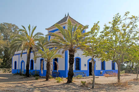Old house of the guardian in white and blue of the recreational area of ââthe beach of Casita Azul in Isla Cristina, Huelva, Andalusia, Spainの写真素材