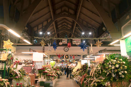 Wroclaw, Poland - December 11, 2019: Market flowers stalls in Wroclaw Market Hall (Hala Targowa) in Poland during a night of christmas.のeditorial素材