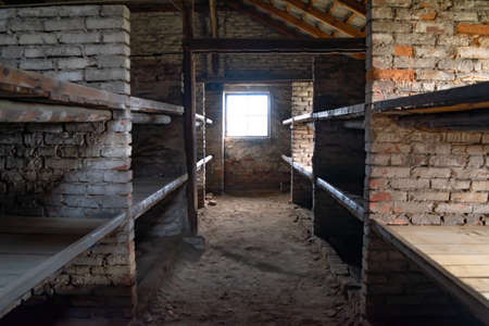 Birkenau, Poland - December 15, 2019: Wooden bunk beds in a barrack in Auschwitz - Birkenau Concentration Campのeditorial素材