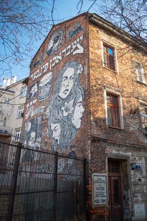 Krakow, Poland - December 13, 2019: Black and white mural street art on a brick wall by unidentified artist in the jewish quarter Kazimierz in Krakow Old town, now a UNESCO world heritage site.のeditorial素材