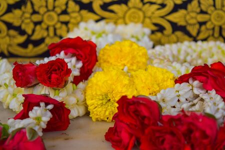 Withe, red and yellow flower offering in a templeの写真素材