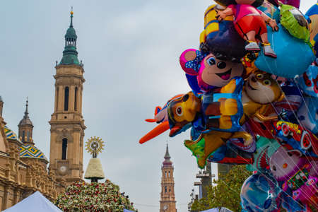 Saragossa, Spain - October 12, 2017: View of the Plaza del Pilar on the day of the flower offering with the domes and towers of the Basilica of Nuestra SeÃ±ora del Pilar, La Seo and some children's balloons.のeditorial素材