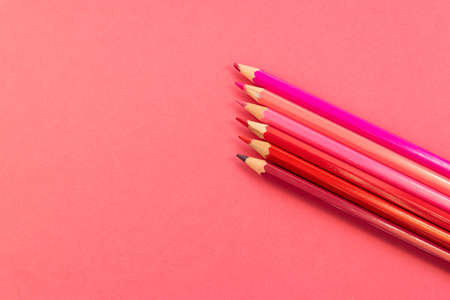 Pink pencils placed in parallel and inclined upwards on a pink backgroundの写真素材