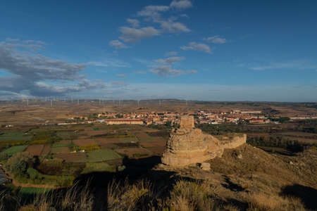 Ruins of the Arab castle in Maria de Huerva near Zaragoza early in the morning with the town and windmills of La Muela in the backgroundのeditorial素材