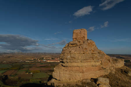 Ruins of the Arab castle at Maria de Huerva near Zaragoza early in the morning with the windmills of La Muela in the backgroundのeditorial素材