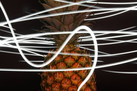 Long exposure with a flashlight, with a pineapple as a main object.の写真素材