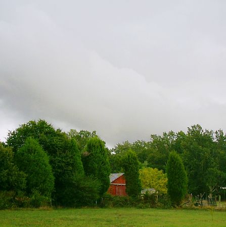Red barn during stormy weatherの写真素材