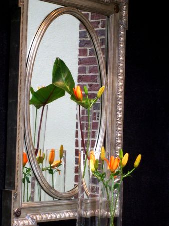 Flower arrangement at a mirrorの写真素材