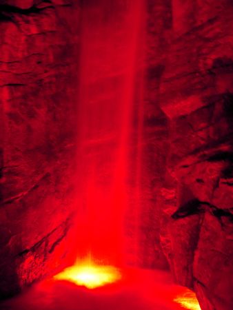 Red-lit waterfall at night