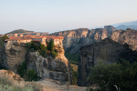 Beautiful view of Monastery and Meteora mountains at sunsetの写真素材