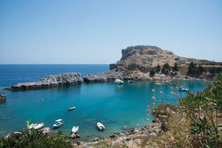 Beautiful bay close to Lindos, Rhodes, Greece. Many boats, blue water on a sunny dayの写真素材