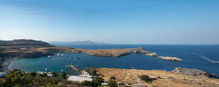 Beautiful panoramic view of Lindos bay with beach, rocks and Mediterranean sea. Rhodes, Dodecanese, Greece.の写真素材