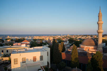 Beautiful aerialv iew of Rhodes old town and harbor just before sunset. Suleiman Mosque wand tower. Dodecanese. Greece.の写真素材