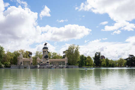 Lake at Retiro park, Madrid, on a sunny day. Some boats and people in the distanceの写真素材
