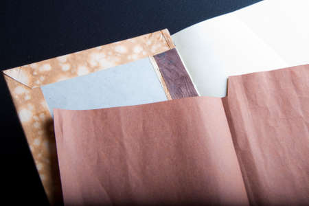 The process of book binding; adding the brown endsheets. Black backgroundの写真素材