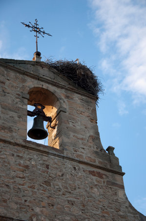 Church tower with a stork nest and the stork in it, seen from below. Rural area or Soria, Spain, Europeの写真素材