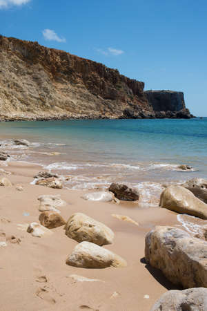 Rocks on an empty beach with no people, sunny day. Sagres, Algarve, Portugal, Europeの写真素材