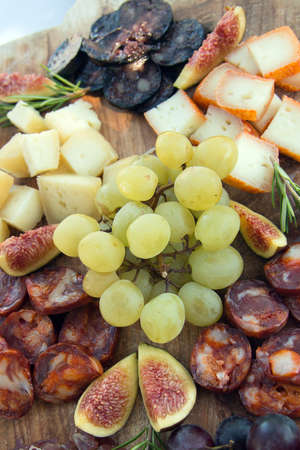 Delicious food on a wooden cutting board seen from above.