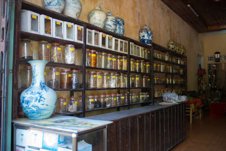 Hue, Vietnam; 08192015: Traditional pharmacy at Hue, Glass jars in a row on shelves. No people. Asia.のeditorial素材