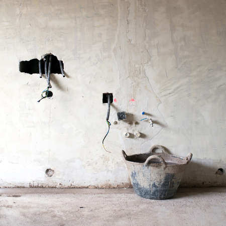 House construction or renovation. Raw walls with holes for wires, electric plugs and water lines. No...