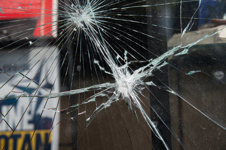 Damaged glass window after a manifestation. Paris, Europe