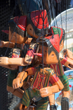 Pinocchio puppets for sale in a street market. Backgrounds. Italyの写真素材